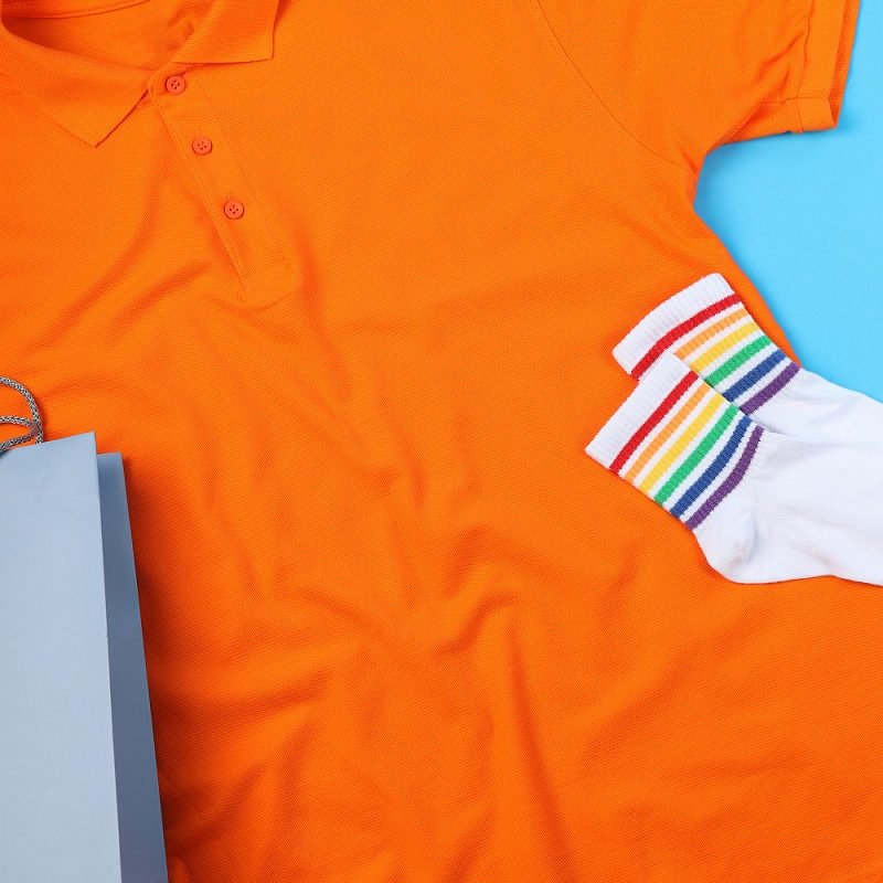 Blank t-shirt, bag and socks on blue background