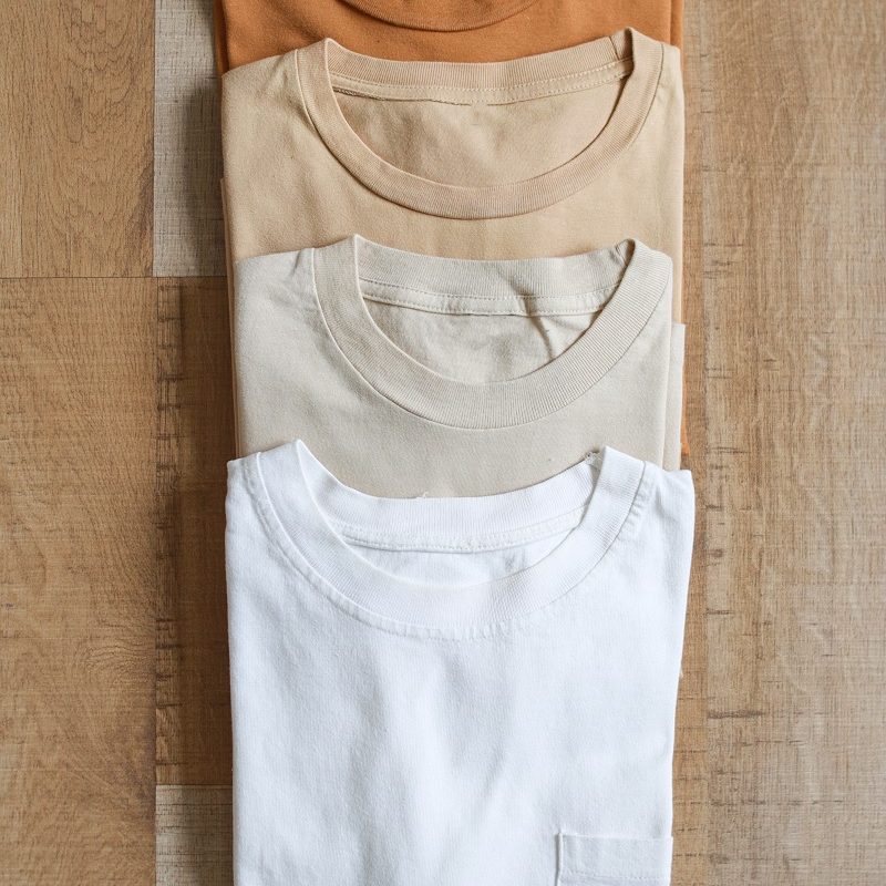 earth-tone-color-t-shirts-on-wooden-table-2024-02-13-21-59-06-utc