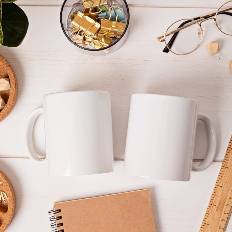 Modern eco friendly desktop with zero waste stationary and white mug mockup. Comfortable working space, sustainable life style concept. Top view, flat lay.