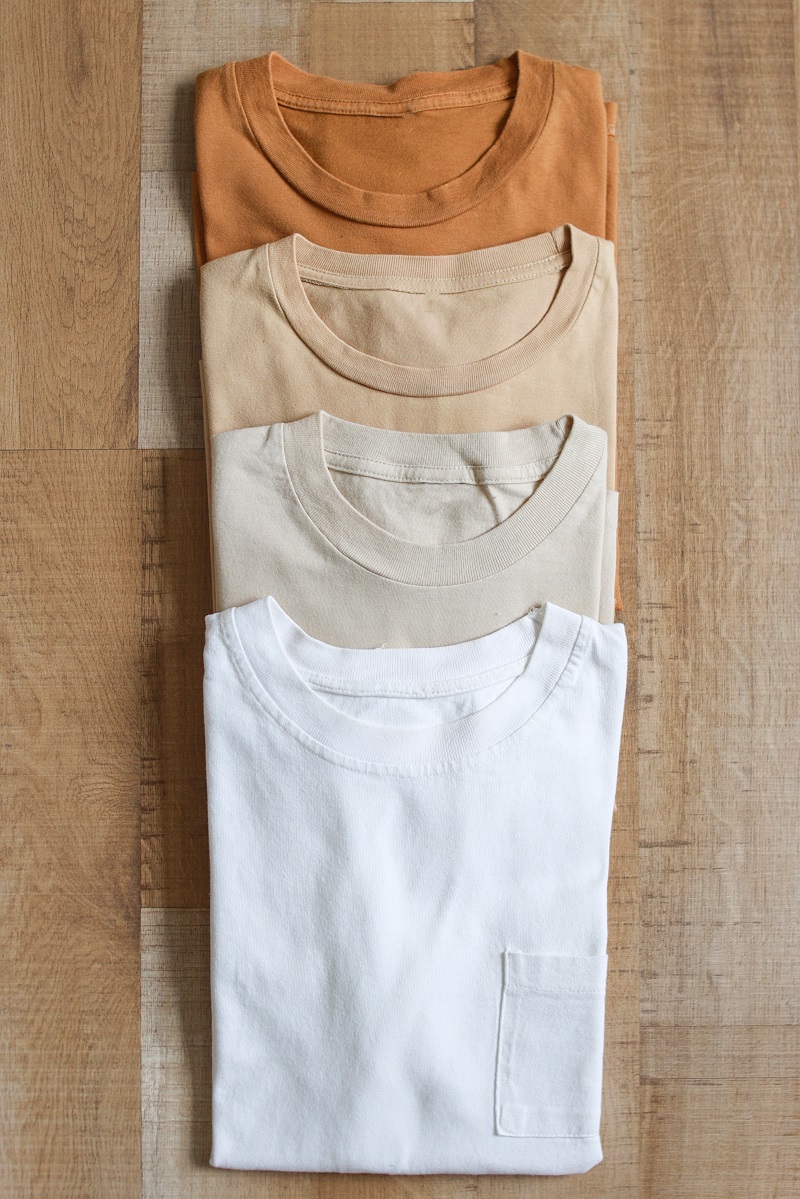 earth-tone-color-t-shirts-on-wooden-table-2024-02-13-21-59-06-utc