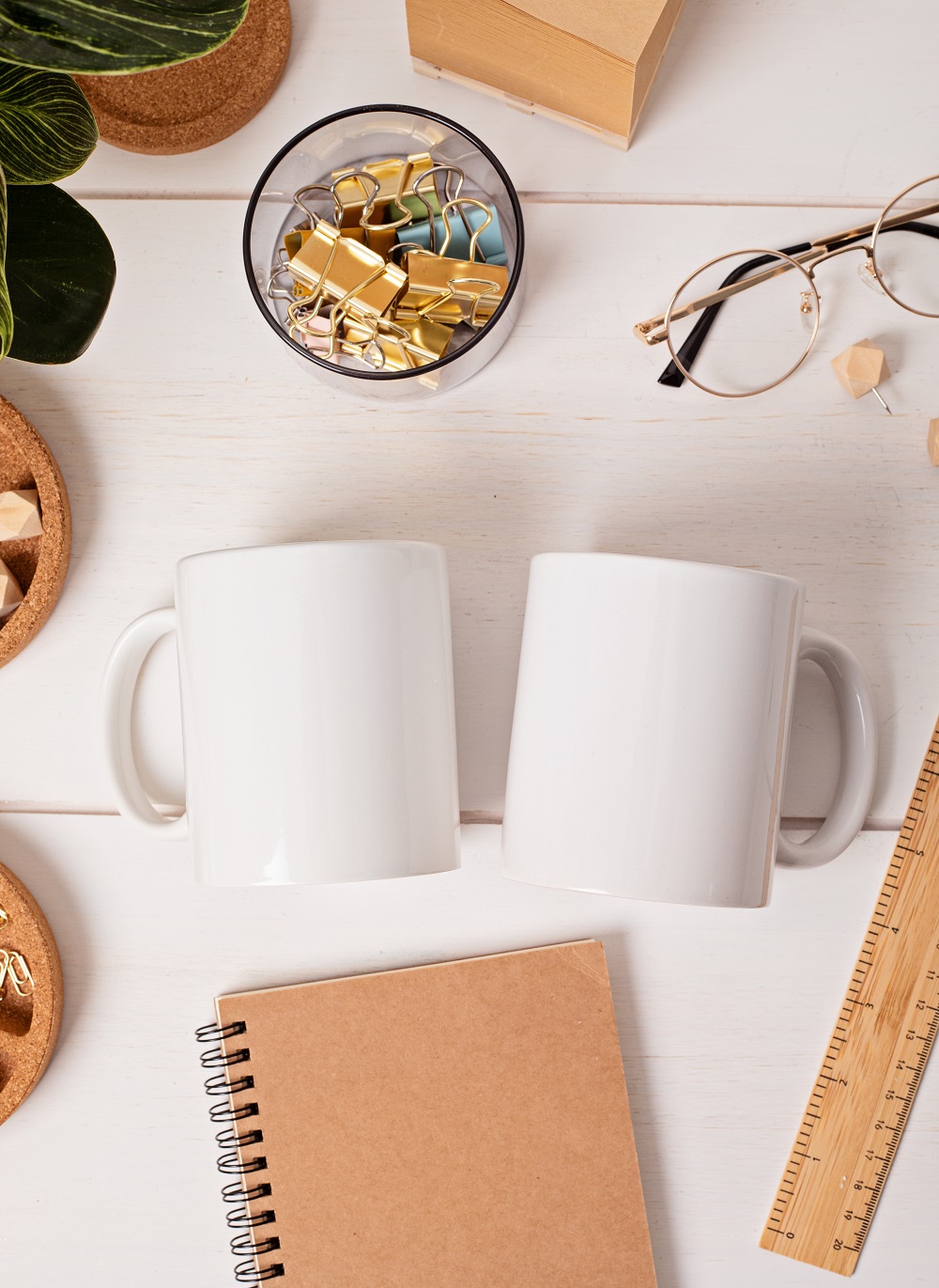 Modern eco friendly desktop with zero waste stationary and white mug mockup. Comfortable working space, sustainable life style concept. Top view, flat lay.
